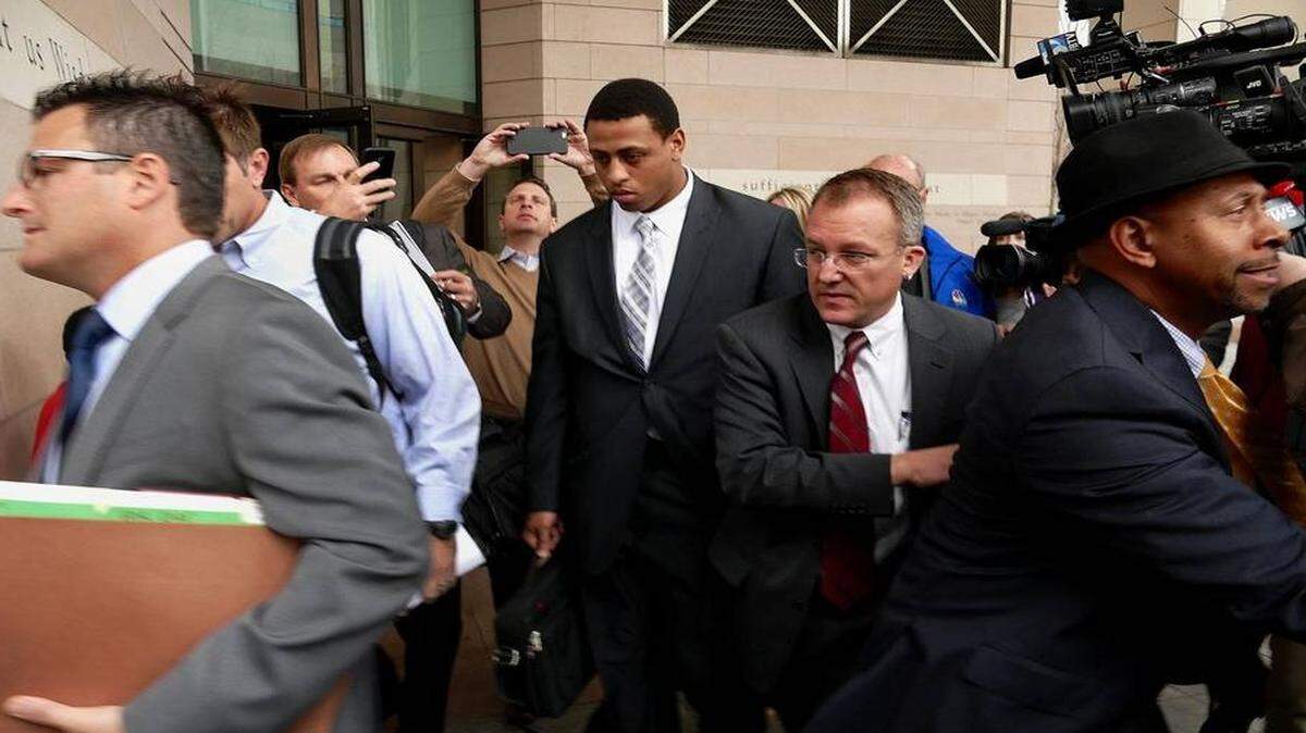 
Former Carolina Panthers defensive end Greg Hardy (now with the Dallas Cowboys) walks to a parking deck from the Mecklenburg County Courthouse with the media seeking comment in Charlotte, NC on Monday, February 9, 2015. Hardy's domestic-abuse case was abruptly dismissed Monday because his accuser who is believed to have reached an undisclosed civil settlement with Hardy could not be found to testify.

