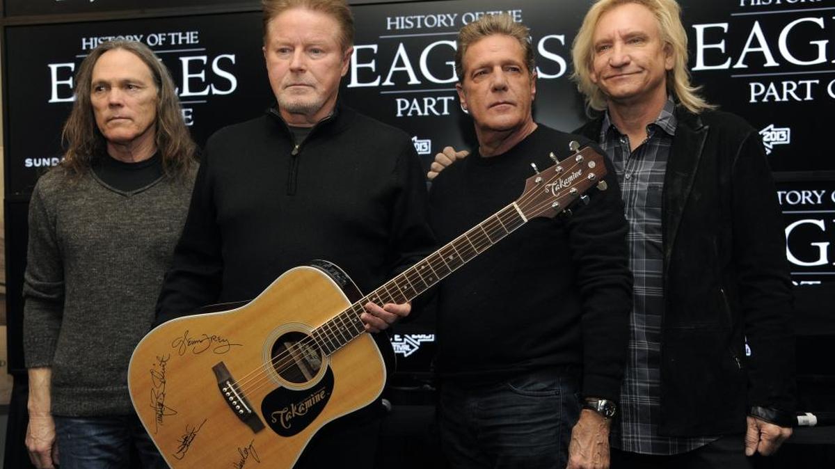 In this Jan. 19, 2013 file photo, members of the Eagles, from left, Timothy B. Schmit, Don Henley, Glenn Frey and Joe Walsh of The Eagles pose with an autographed guitar after a news conference at the 2013 Sundance Film Festival, in Park City, Utah. The band sued the owners a Mexican hotel on May 1, 2017, claiming it’s capitalizing off the band’s hit, “Hotel California,” even though it has nothing to do with the song.