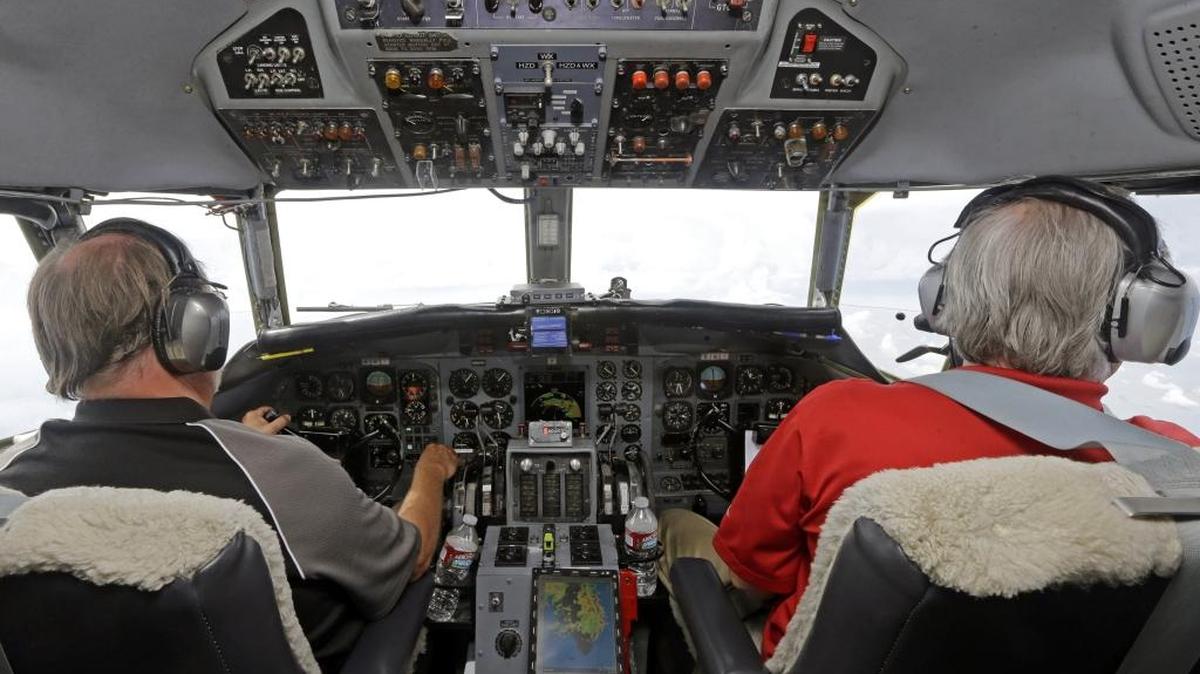 In this Aug. 15, 2014 photo, Captain Randy Moore, left, and co-pilot Mark Johnson, right, fly a Convair 580 test plane during a flight demo of the Honeywell InturVue weather radar over Florida. Advances in radar are helping pilots avoid storms that can injure and upset passengers and even damage planes.