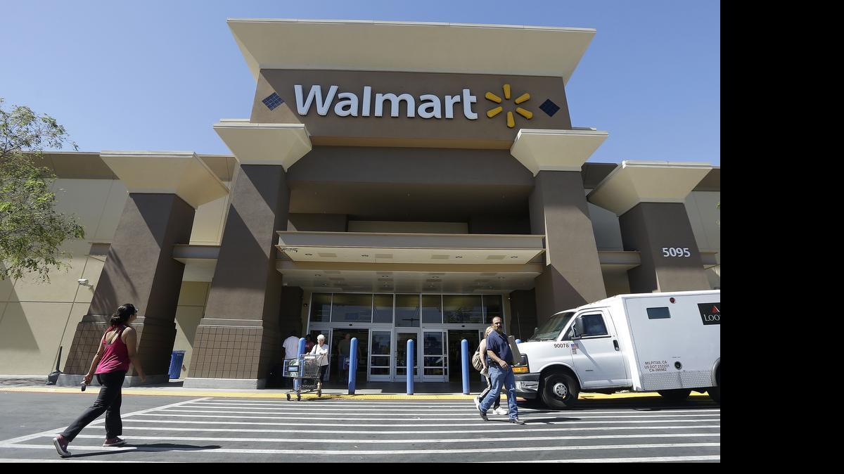 
Customers walk outside of a Wal-Mart store in San Jose, Calif. Wal-Mart, the nation’s largest food retailer, is urging its thousands of U.S. suppliers to curb the use of antibiotics in farm animals and improve treatment of them. 
