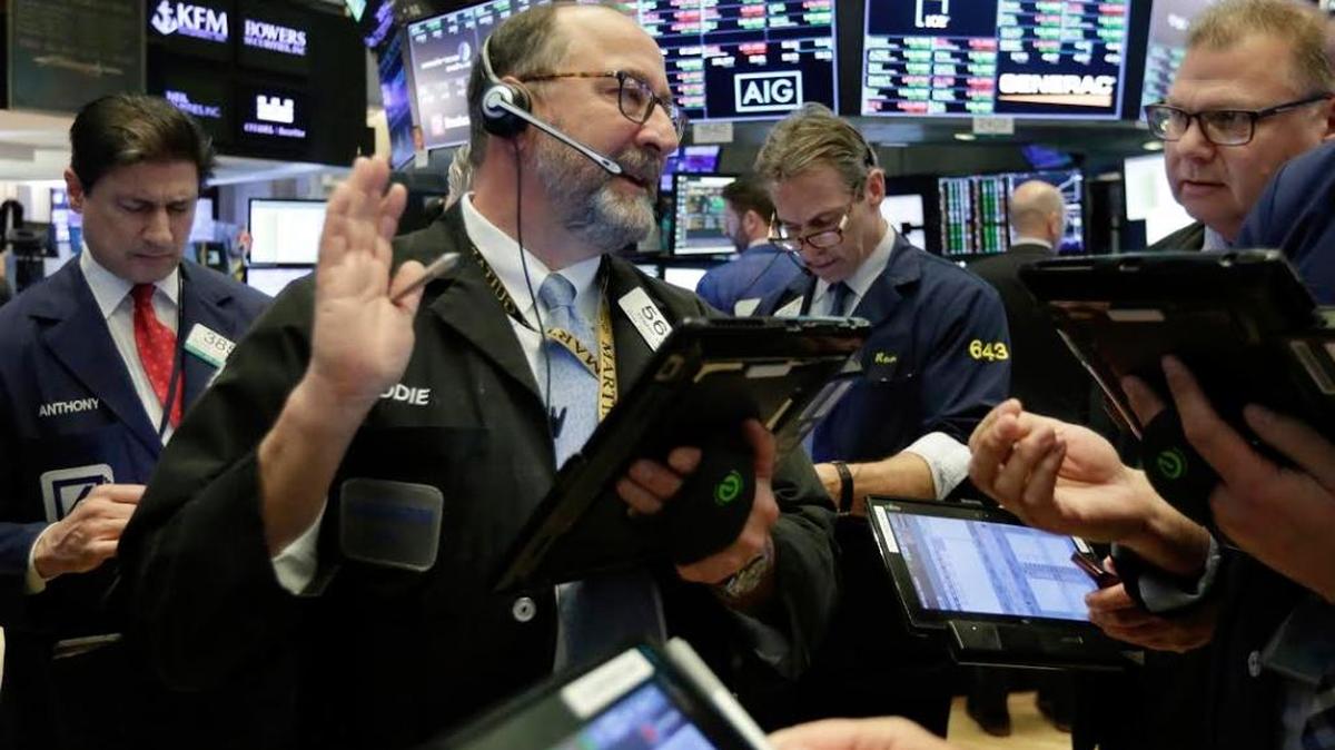 Edward Landi, foreground left, works with fellow traders on the floor of the New York Stock Exchange, Thursday, Feb. 15, 2018. Stocks are opening higher on Wall Street after several U.S. companies reported solid results.