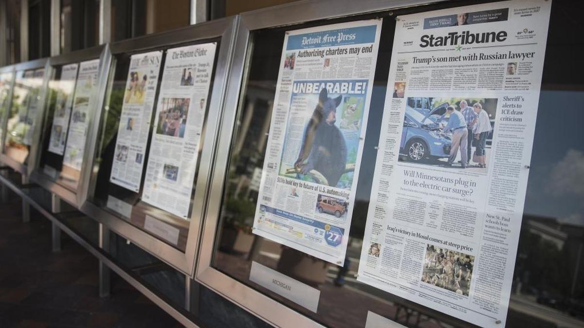 Newspaper front pages are displayed at the Newseum in Washington.