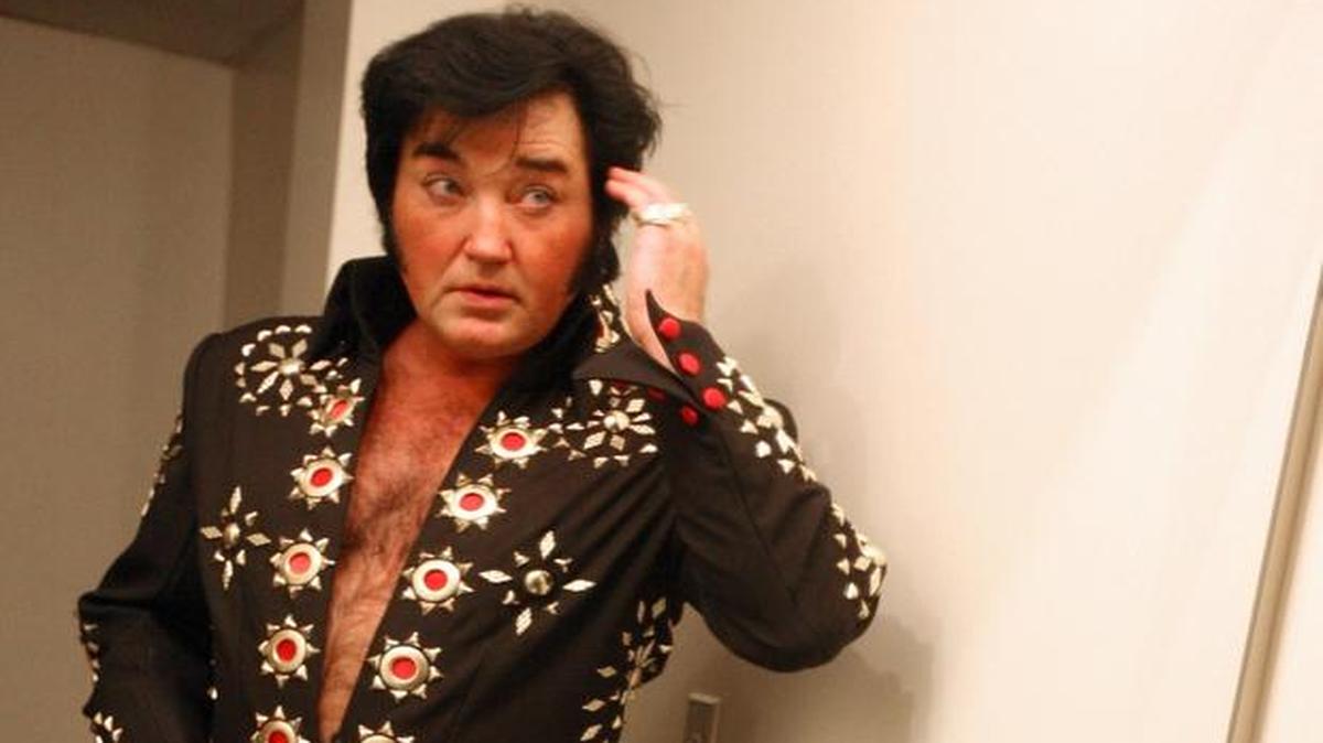 Before the second half of his show, Eddie Miles dons the clothes and style of Elvis at a tribute performance at the Alabama Theatre.