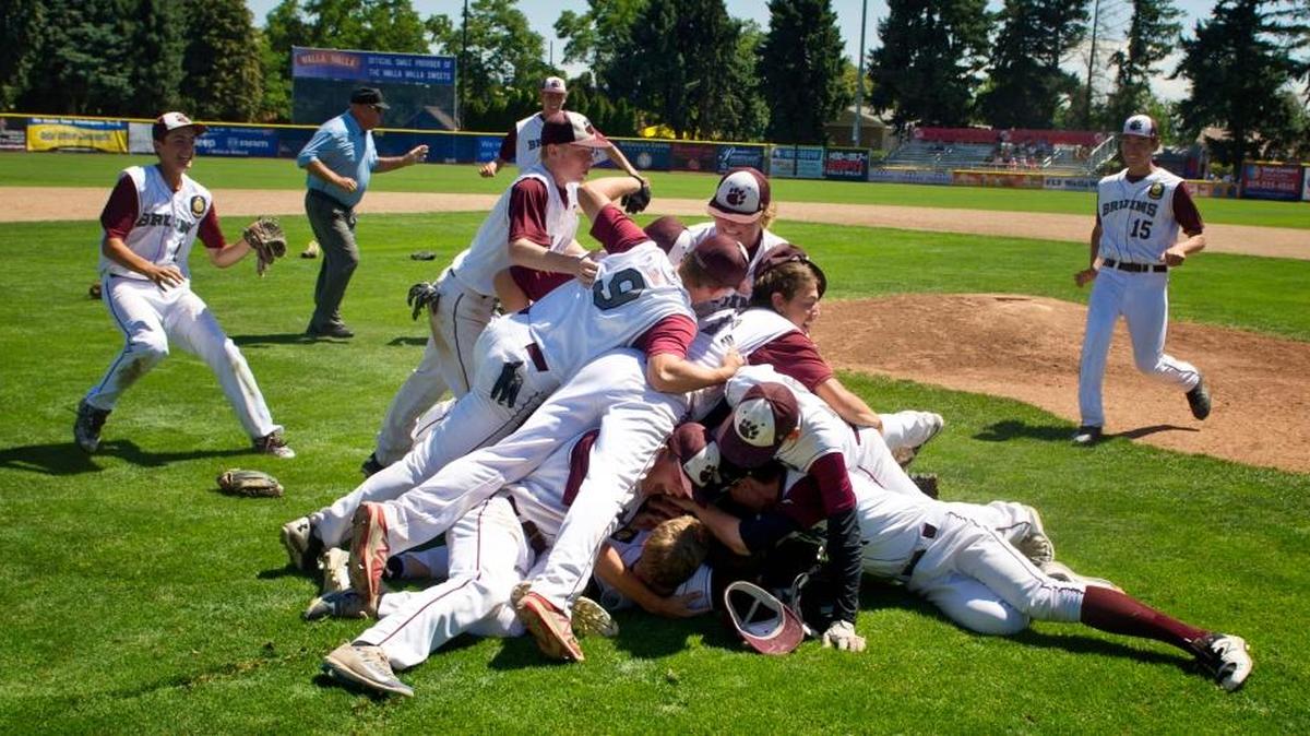 The Walla Walla Bruins dogpile near the mound after the final out of their championship game with Mount Vernon on July 27 in Walla Walla, Wash., for the AA American Legion state baseball championship.