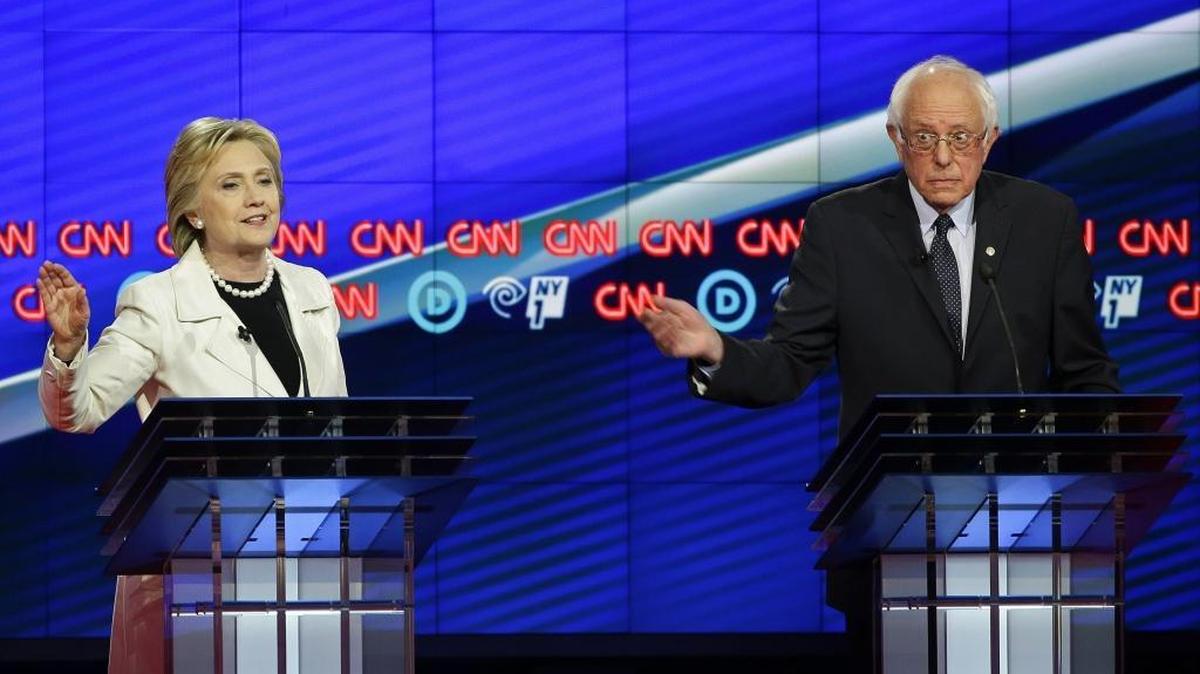 Democratic presidential candidate Sen. Bernie Sanders, I-Vt., right, gestures while Hillary Clinton speaks during the CNN Democratic Presidential Primary Debate at the Brooklyn Navy Yard Thursday, April 14, 2016, New York.