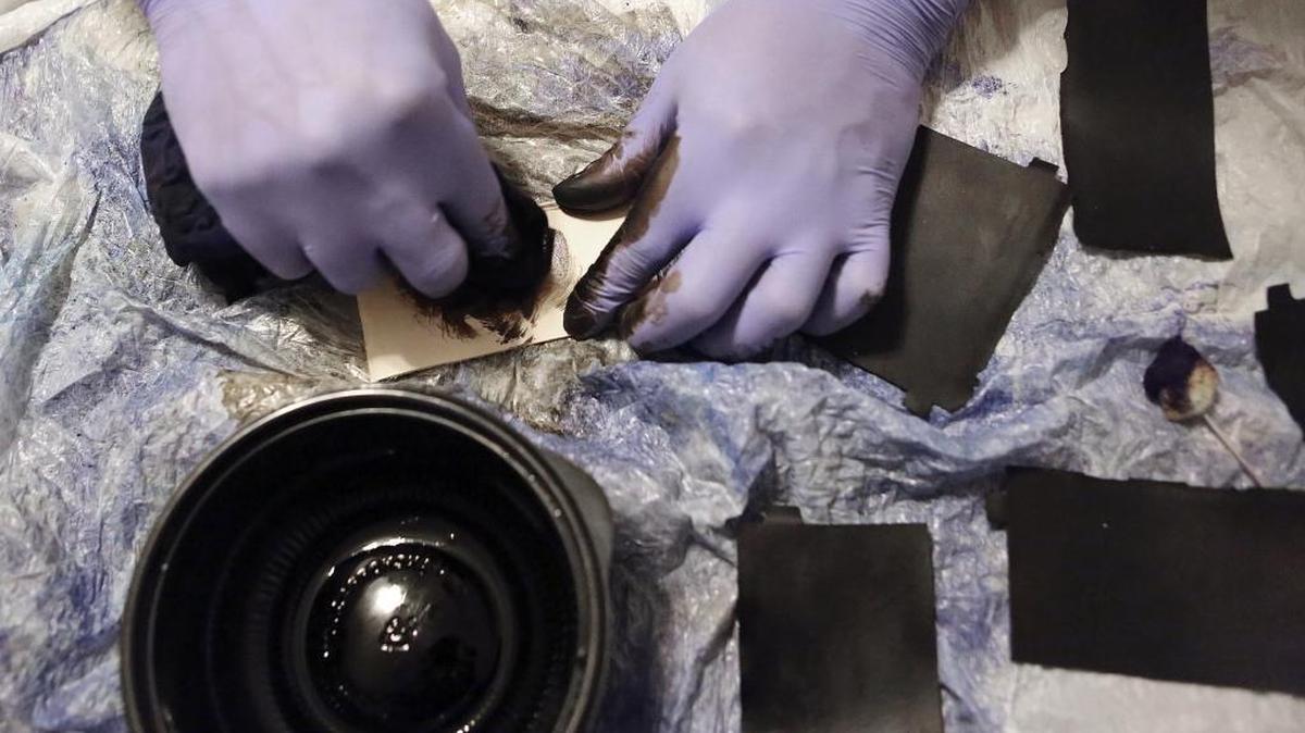 Markese Boggs dyes leather to make a wallet at his Murrells Inlet home on Tuesday, Nov. 17, 2015.