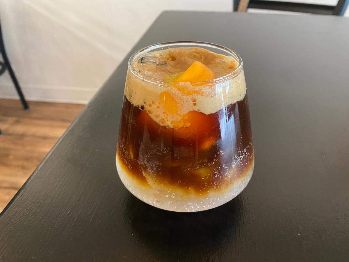 An “espresso tonic” is one of the few unique drinks on Milk and Honey’s menu. It’s made with a shot of espresso, Fevertree elderflower tonic water, and a slice of orange. Photo from Dec. 21, 2022.