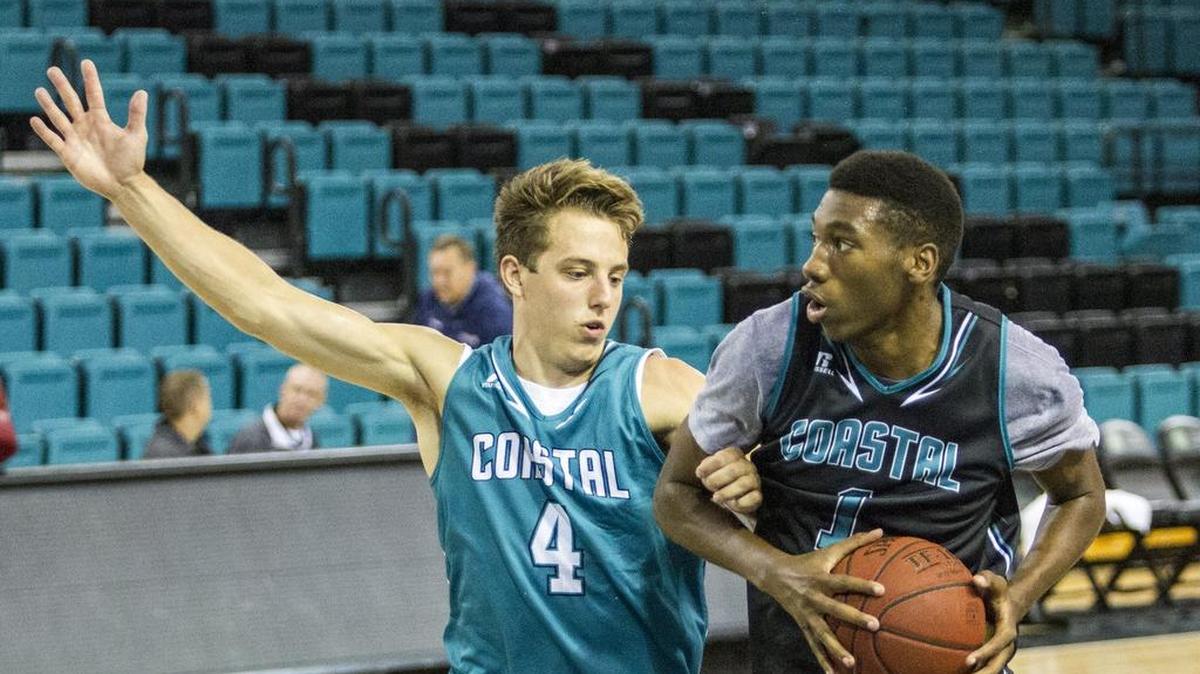 
Christian Adams tries to block Kevin Holmes, Jr. in practice. Coastal Carolina Basketball Practice resumed today with Coach Cliff Ellis taking a hands on approach to getting his team ready for the upcoming season.
