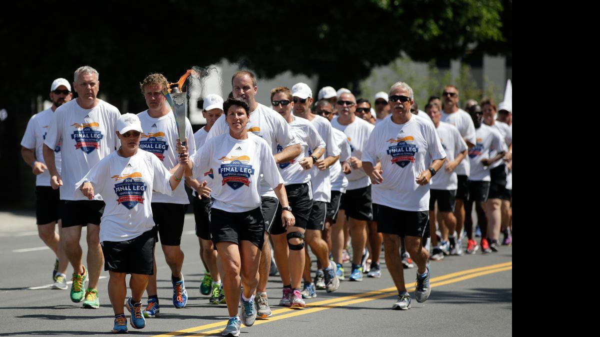 
Torchbearers carrying the Flame of Hope arrive at Los Angeles City Hall, on July 24, 2015. More than 7,000 athletes from more than 175 countries, the most to visit Los Angeles since the 1984 Summer Olympics, are in town and ready to hit golf balls and tennis balls, kick soccer balls, swim laps, skate, run a triathlon and lift weights at the 2015 Special Olympics World Games.
