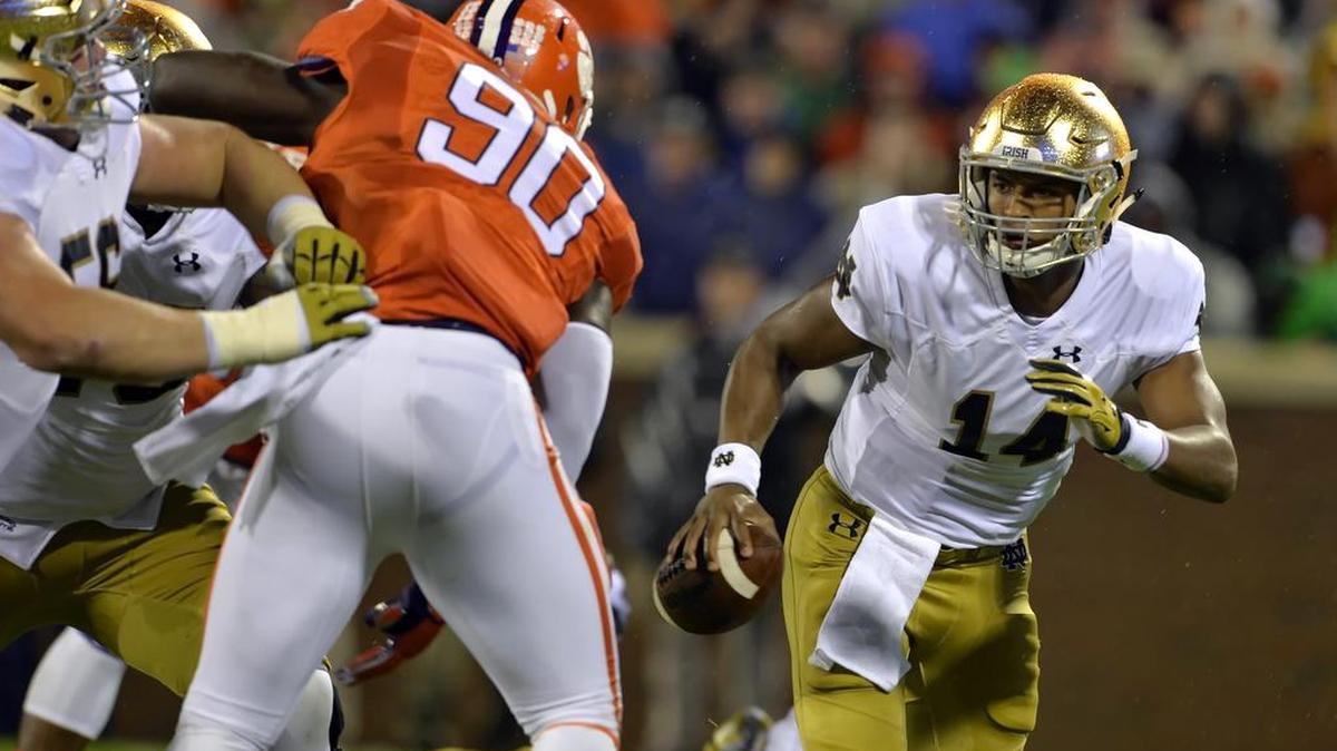 
Notre Dame quarterback DeShone Kizer, right, scrambles out of the pocket while pressured by Clemson's Shaq Lawson during the first half of an NCAA college football game Saturday, Oct. 3, 2015, in Clemson, S.C.
