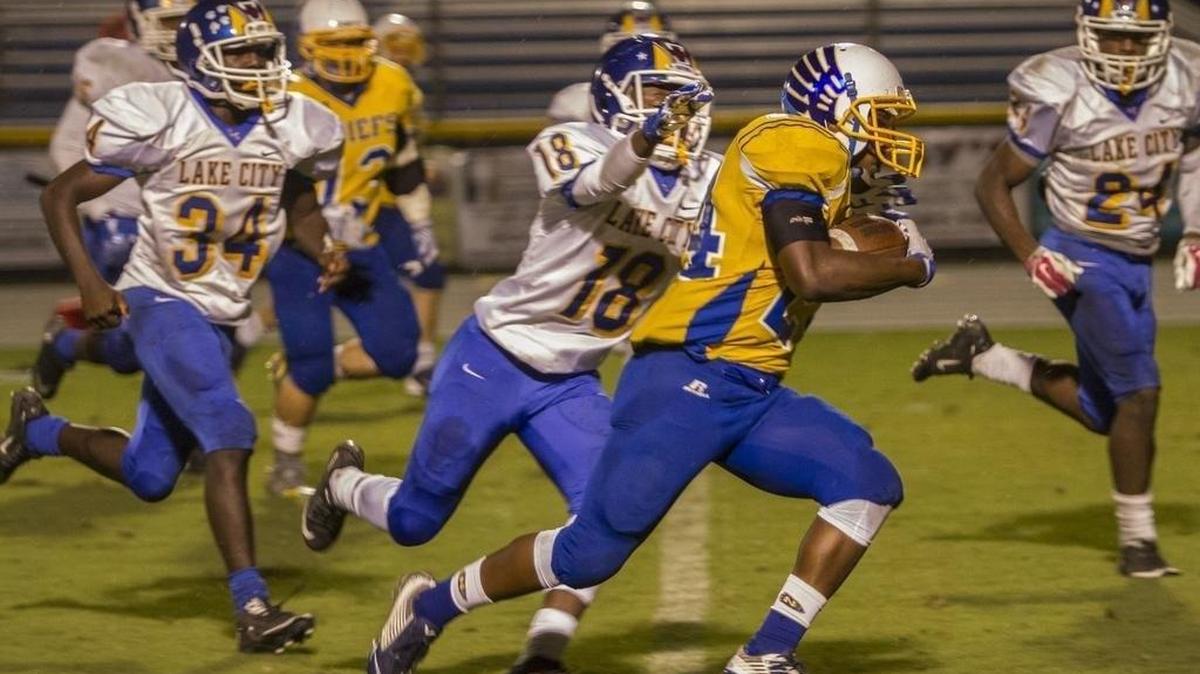 
North Myrtle Beach's Dequan Montgomery takes the ball down field for big yardage against Lake City. North Myrtle Beach beat Lake City 33-19. 
