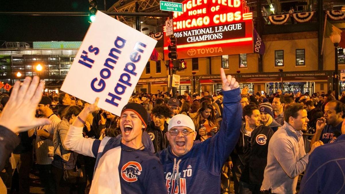 Chicago Cubs fans celebrate outside Wrigley Field after the Cubs defeated the Los Angeles Dodgers 5-0 in Game 6 of NLCS to advance to the World Series.