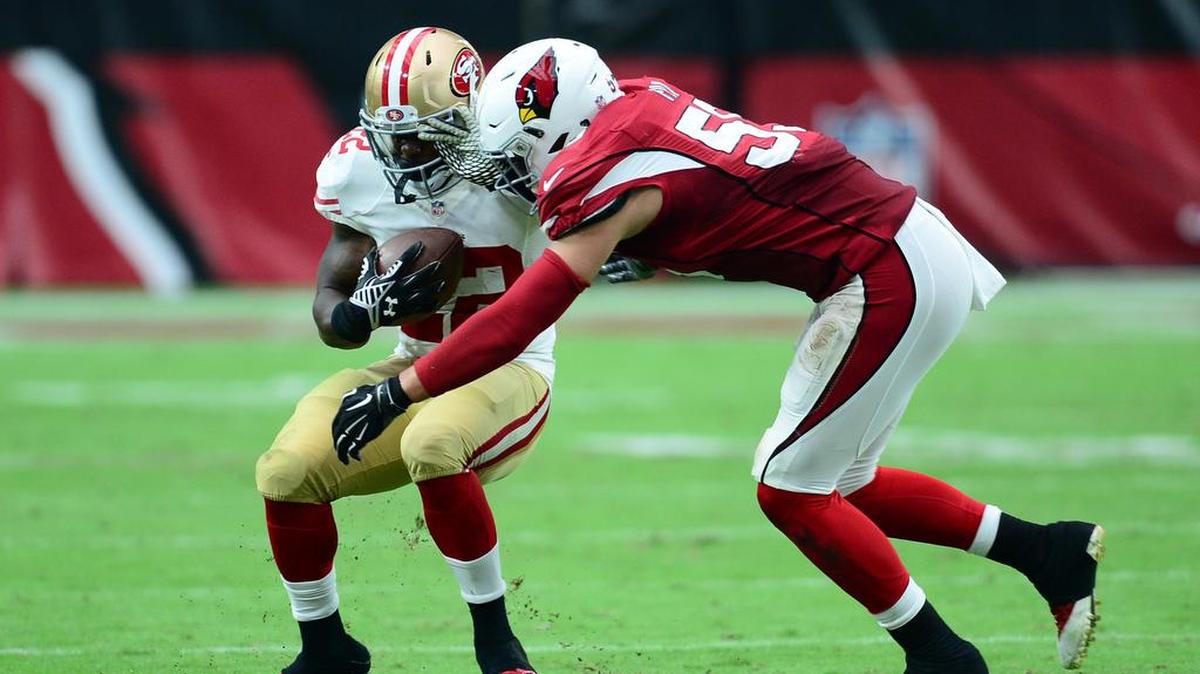 Sep 27, 2015; Glendale, AZ, USA; Arizona Cardinals outside linebacker Alani Fua (59) tackles San Francisco 49ers running back Mike Davis (22) at University of Phoenix Stadium. Mandatory Credit: Joe Camporeale-USA TODAY Sports