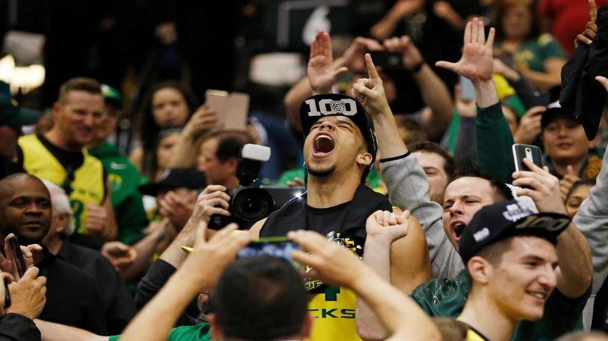 Oregon forward Dillon Brooks celebrates with fans after his team defeated Utah in an NCAA college basketball game in the championship of the Pac-12 men’s tournament on Saturday.