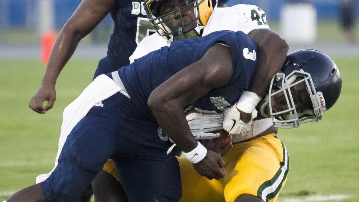 Conway’s Jaylen Moody brings down Georgetown's Fred Taylor in Conway’s 40-8 win in the first game of the 2017-2018 season. Moody has signed a letter of intent to play football at Alabama.