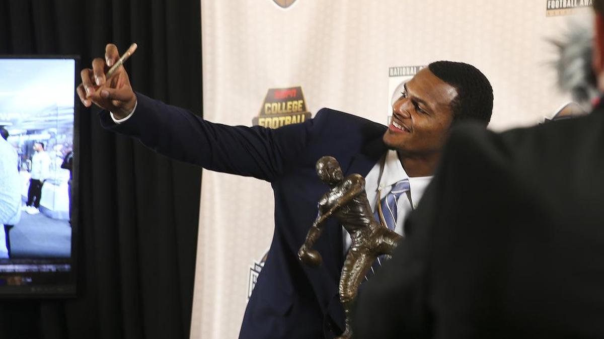 Clemson’s Deshaun Watson takes a photo with the trophy after winning the Davey O’Brien Award as the nation’s best quarterback on Thursday in Atlanta.
