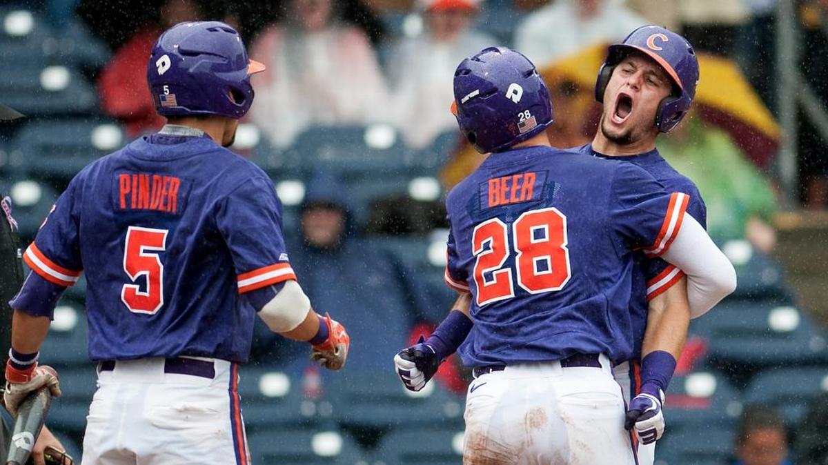 Clemson’s Chris Okey, right, is congratulated by teammates Chase Pinder and Seth Beer after driving in a run during the first inning against Florida State.