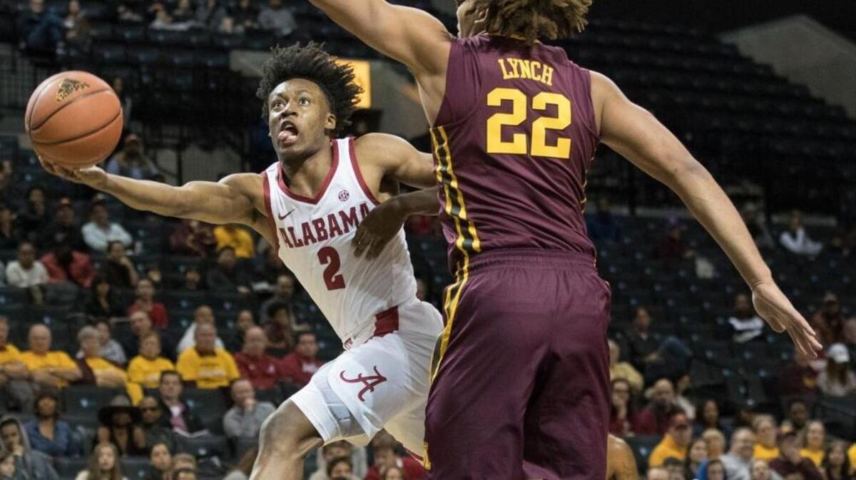 Alabama guard Collin Sexton (2) drives to the basket against Minnesota center Reggie Lynch (22) during the first half Saturday.