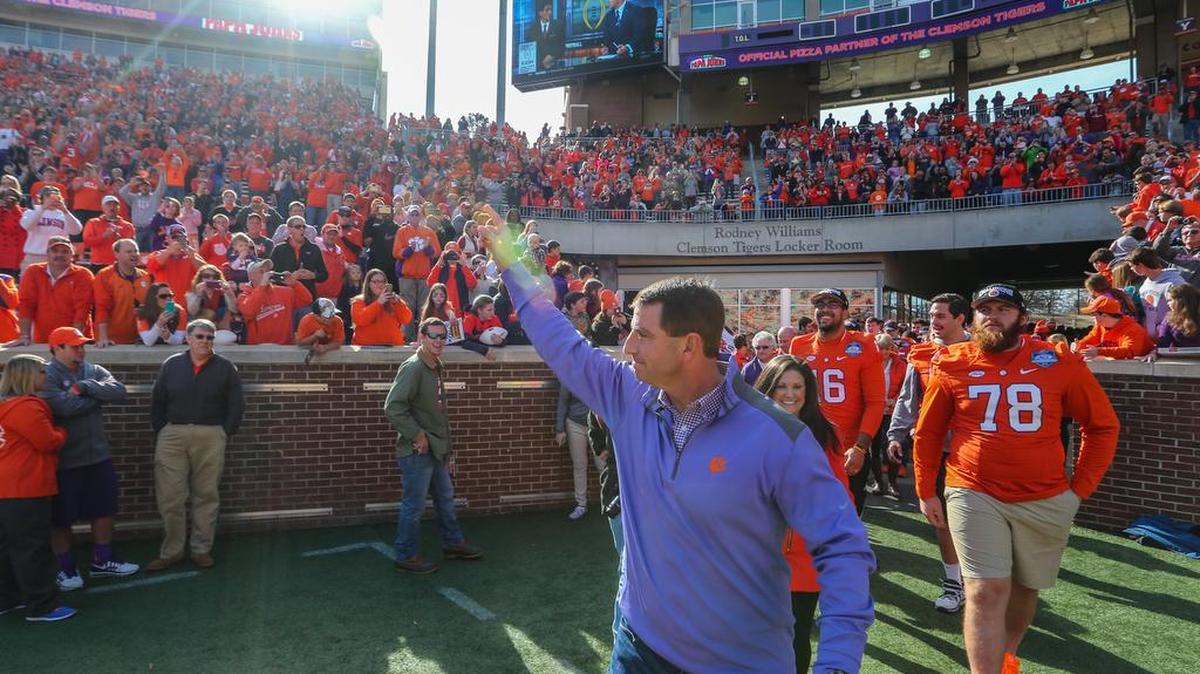 Clemson coach Dabo Swinney acknowledges the applause of the fans who attended his pizza party at Memorial Stadium on Sunday. Each person that came received a free piece of pizza and Swinney and the team came out to listen to the College Football Playoff pairings announced on ESPN. 12/6/15