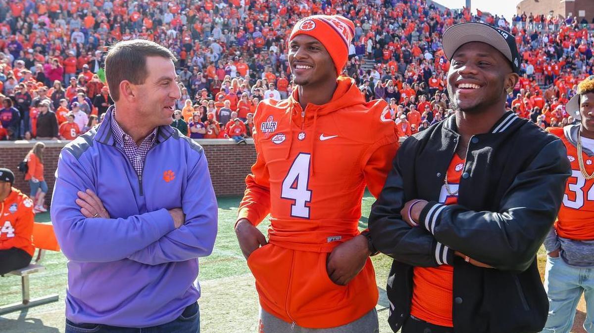 Clemson coach Dabo Swinney talks with Clemson quarterback Deshaun Watson (4) and wide receiver Artavis Scott (3) during his pizza party at Memorial Stadium on Sunday. Each person that came received a free piece of pizza and Swinney and the team came out to listen to the College Football Playoff pairings announced on ESPN. 12/6/15