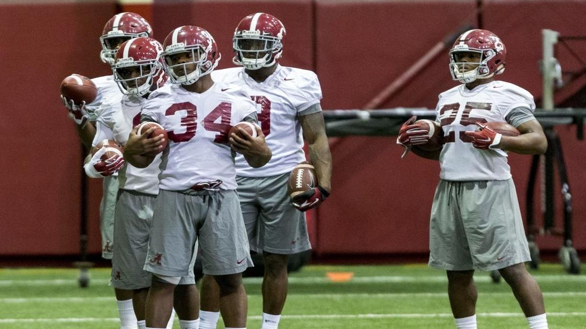 Alabama running back Damien Harris (34) leads off a running back drill during practice last week.