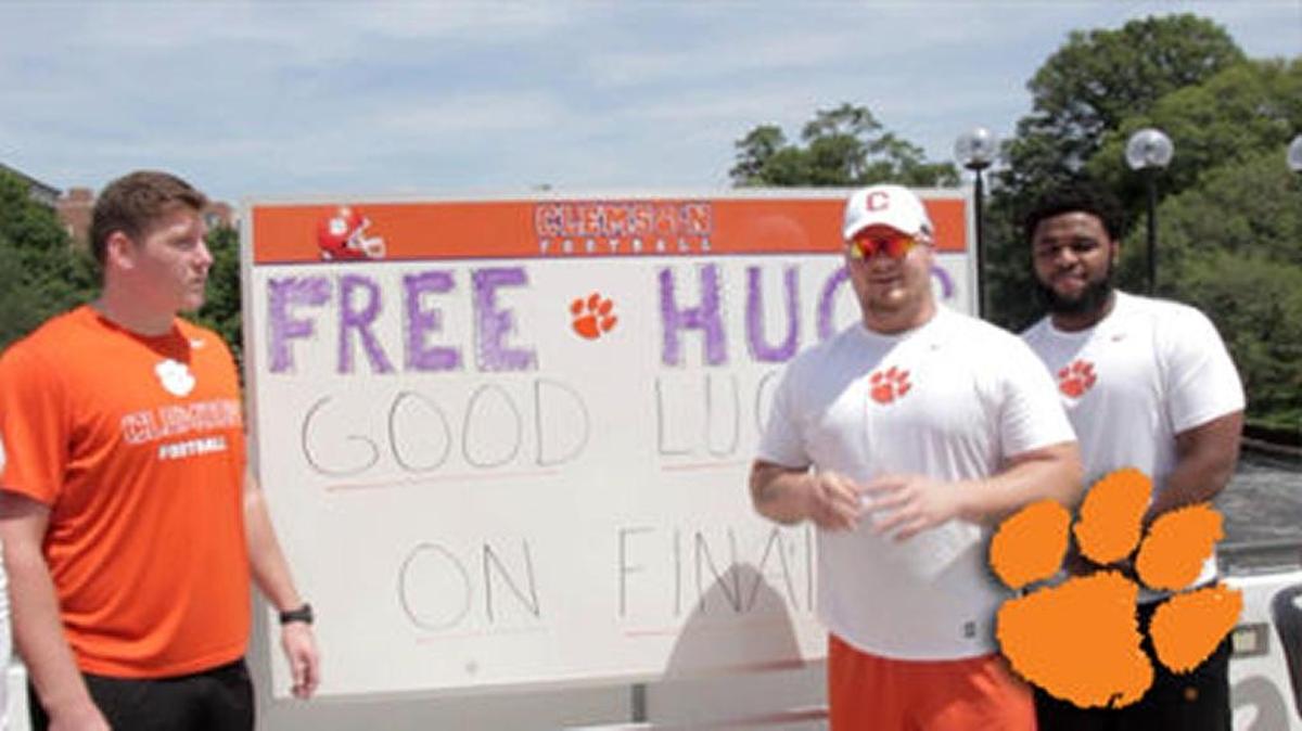 Clemson football players delivered hugs, lollipops and good wishes to students during finals week on the Clemson University campus.