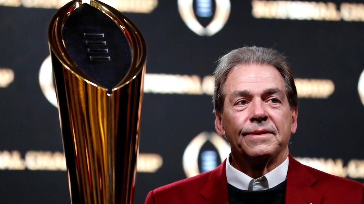 Alabama head coach Nick Saban poses next to the NCAA college football championship trophy at a press conference in Atlanta on Tuesday.