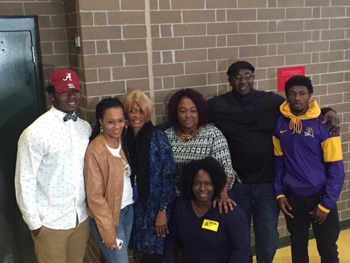 Jaylen Moody (left) with family members after signing his letter of intent to play football at Alabama.