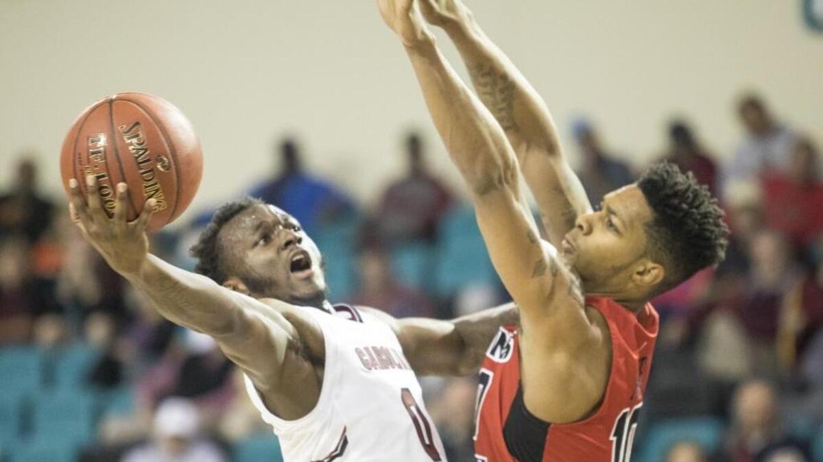 The University of South Carolina's David Beatty goes up against Illinois State’s Isaac Gassman. USC lost to Illinois State 69-65 on Thursday during the first game of the Puerto Rico Tip-Off tournament, which runs through Sunday at the HTC Center in Conway.