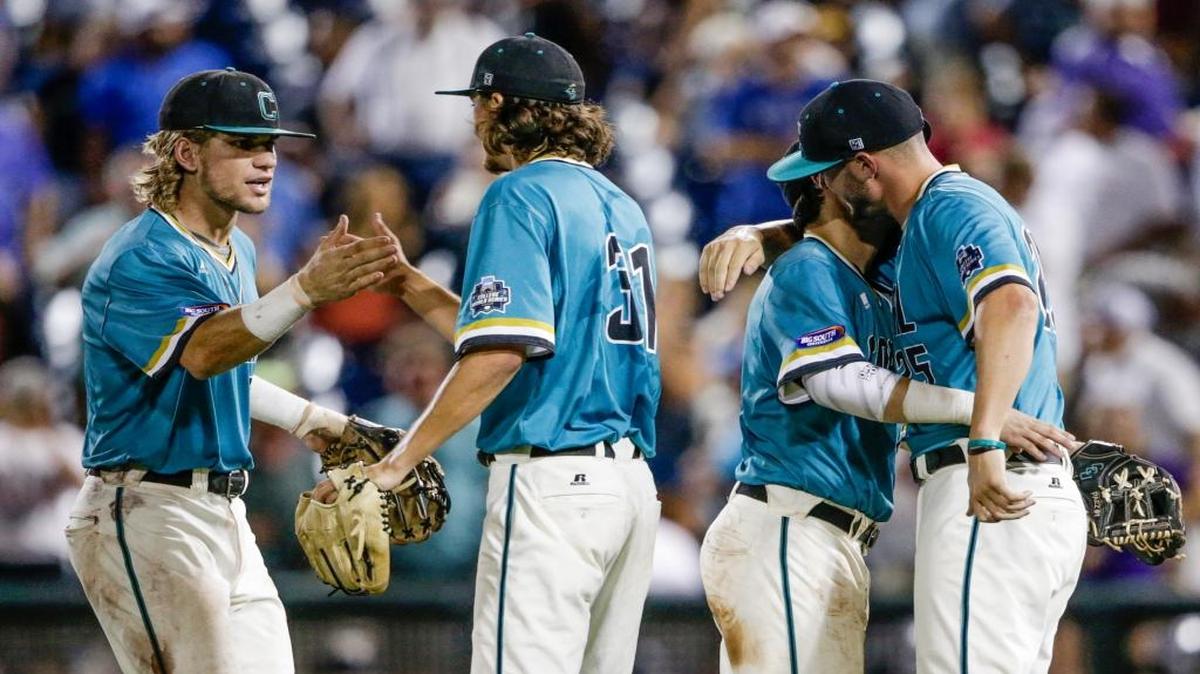 Coastal Carolina’s Zach Remillard, left, Bobby Holmes (31) Michael Paez, and Mike Morrison, right, celebrate their 7-5 win over TCU on Saturday.
