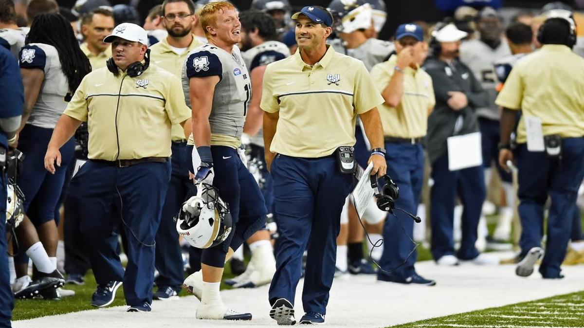 Jamey Chadwell (center) is 30-12 in his four seasons as the head coach at Charleston Southern.