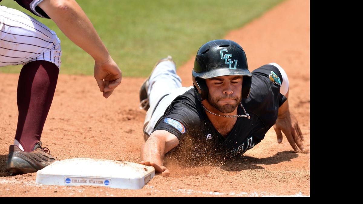 
Coastal Carolina’s Anthony Marks (right) dives back to first base to avoid being picked off during the sixth inning against Texas A&M.
