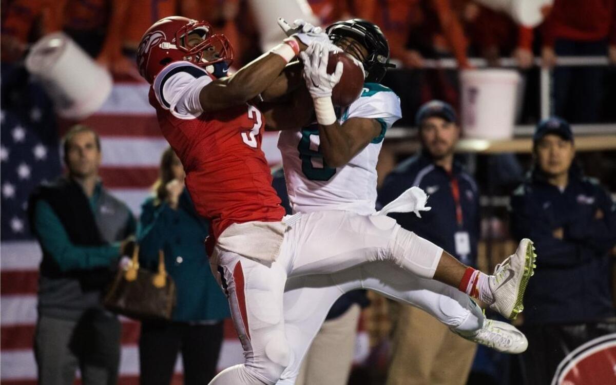 Liberty’s Stephon Masha and Coastal Carolina’s Chris Jones try to gain possession of the ball during last year’s game between the teams.