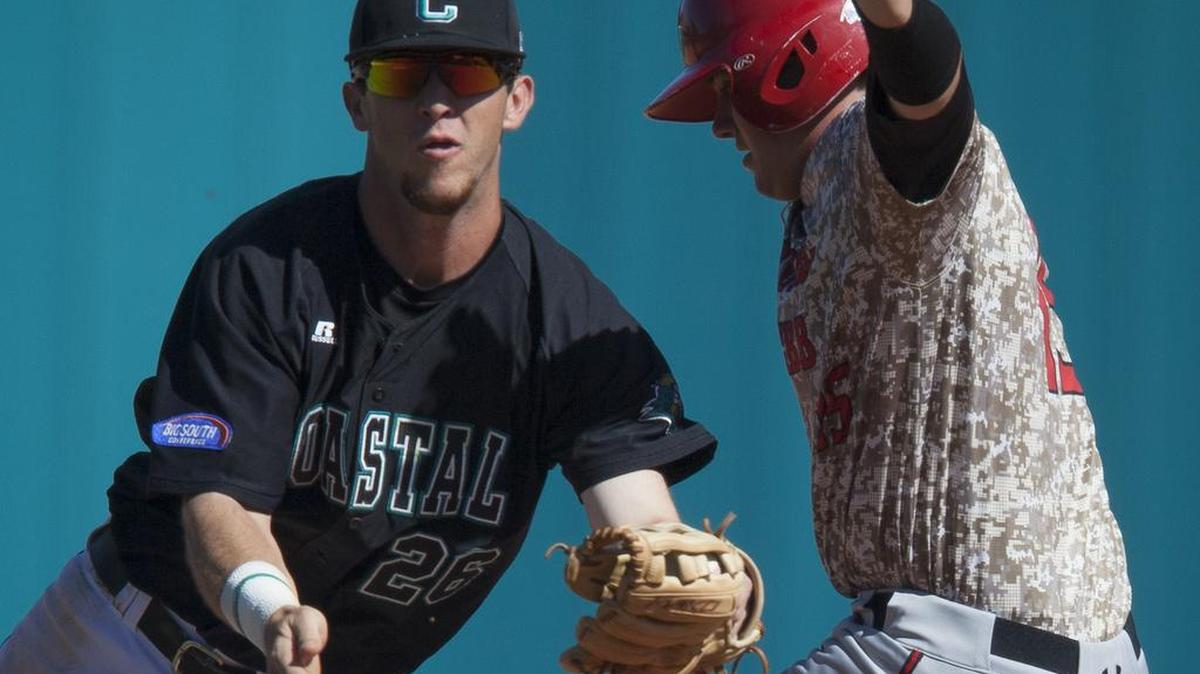 Coastal Carolina second baseman Seth Lancaster (left) tags out Gardner-Webb’s Justin Kunz during Sunday’s game at Springs Brooks Stadium in Conway.