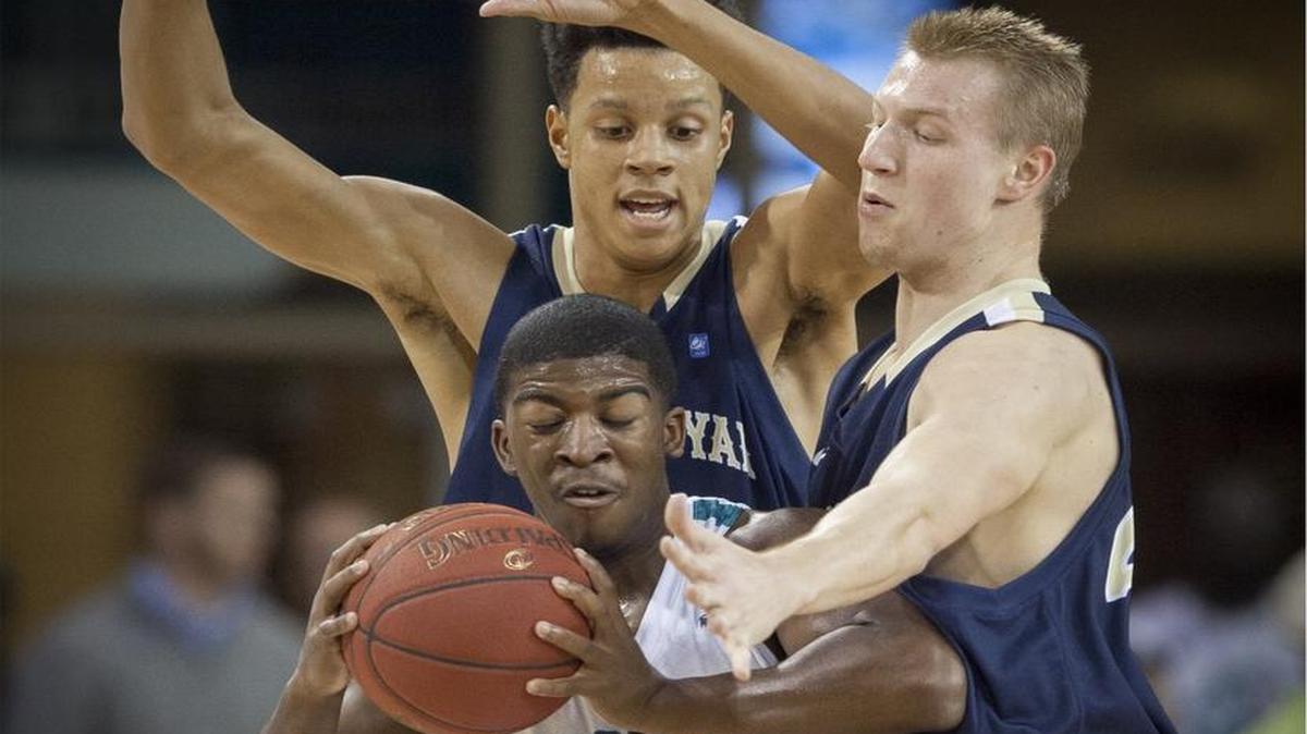Coastal Carolina's Jaylen Shaw finds it tough getting past N.C. Wesleyan’s Shannon Huff and John Edwards during the first half of Wednesday’s game at The HTC Center.