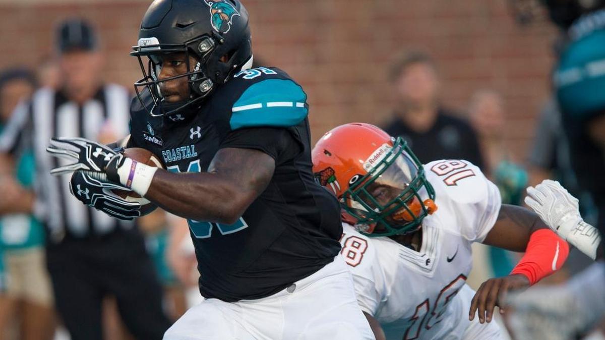 Coastal Carolina senior running back De’Angelo Henderson (31) breaks free from Florida A&M defensive back Jacques Bryant (18) for a first-quarter touchdown.