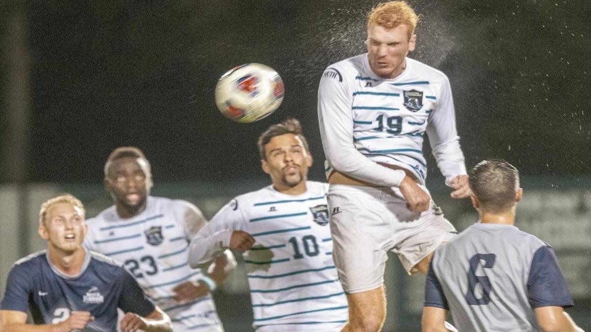 Coastal Carolina’s Louis Dargent (top) heads a ball in last season’s NCAA tournament first-round matchup against North Florida.