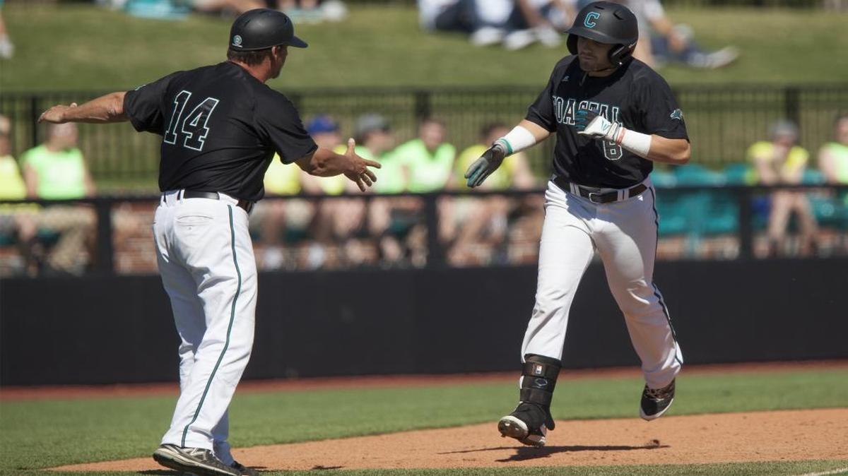 Coastal Carolina coach Gary Gilmore (left) gestures to Connor Owings (6) after Owings’ two-run home run against Gardner-Webb last Sunday.