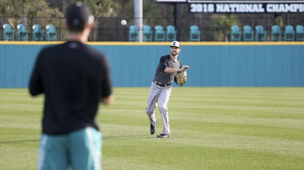 Coastal Carolina pitcher Jason Bilous tosses to a teammate during the Chanticleers’ first practice of 2018 at Springs Brooks Stadium.