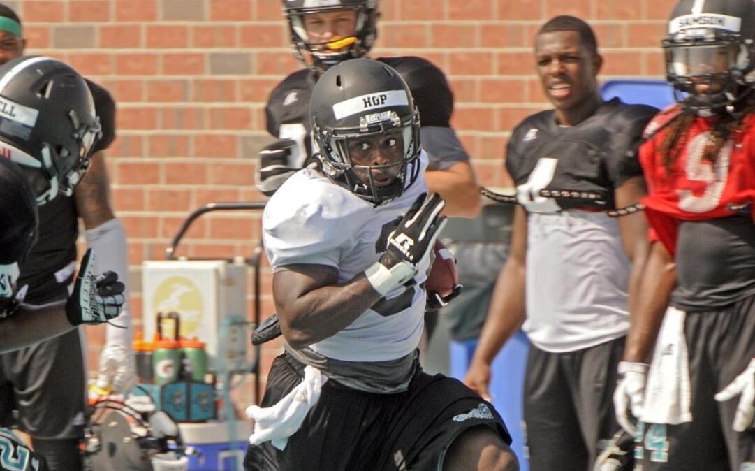 
Coastal Carolina junior running back De’Angelo Henderson carries the ball during a rcent practice at Brooks Stadium.
