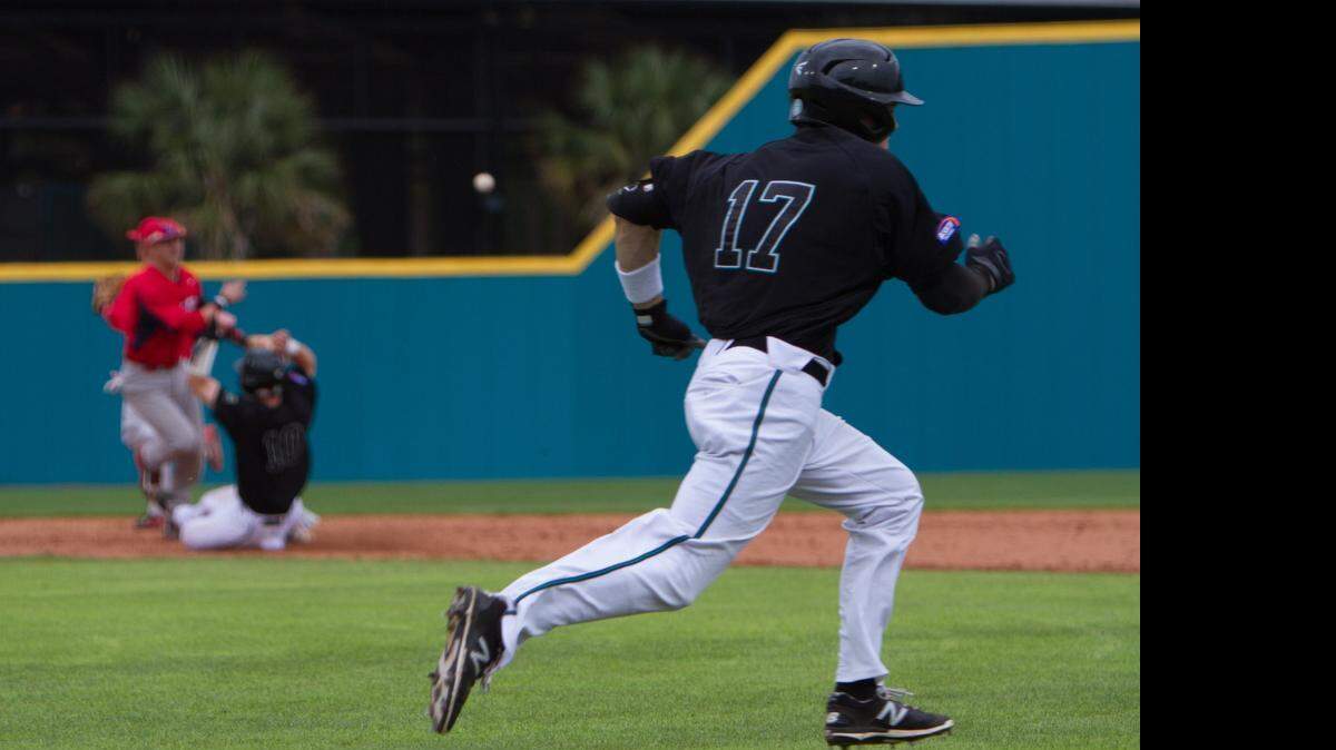 
Coastal Carolina’s Billy Cooke runs to first in attempt to break up a double play at first as teammate Casey Schroeder is out at second. 
