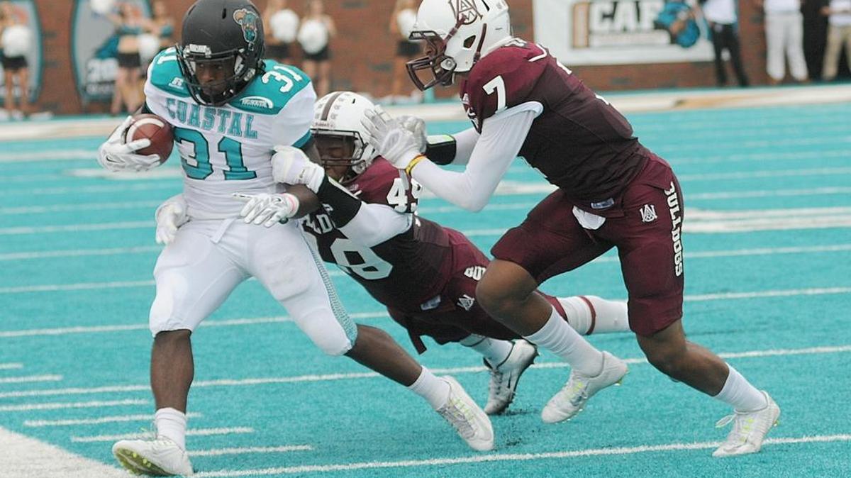 
Coastal Carolina’s De’Angelo Henderson is forced out of bounds by a pair of Alabama A&M defenders Saturday.
