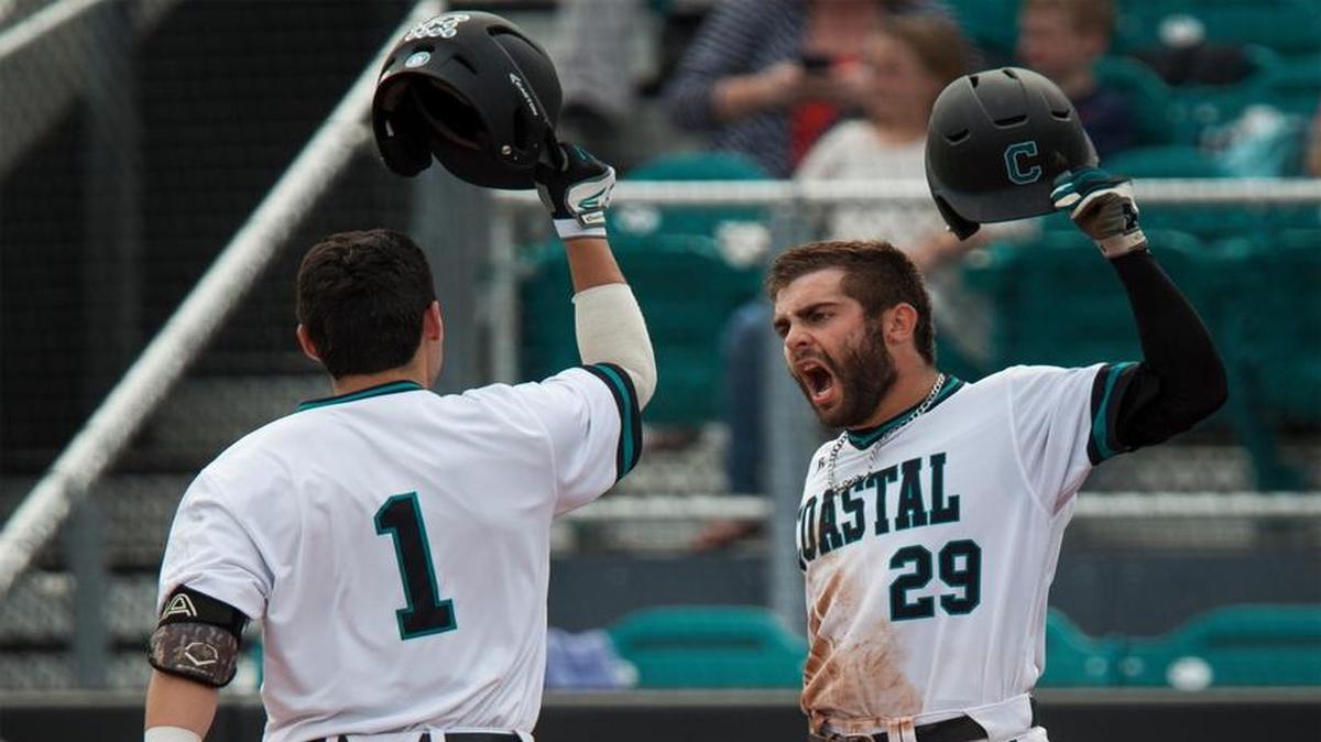 Coastal Carolina players Anthony Marks (29) and Michael Paez (1) celebrate after Paez’s two-run homer against Gardner-Webb.
