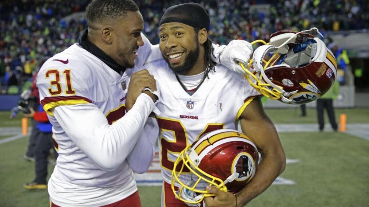 Washington Redskins cornerbacks Josh Norman, right, and Fabian Moreau, left, celebrate after the team’s win over Seattle a few weeks ago.