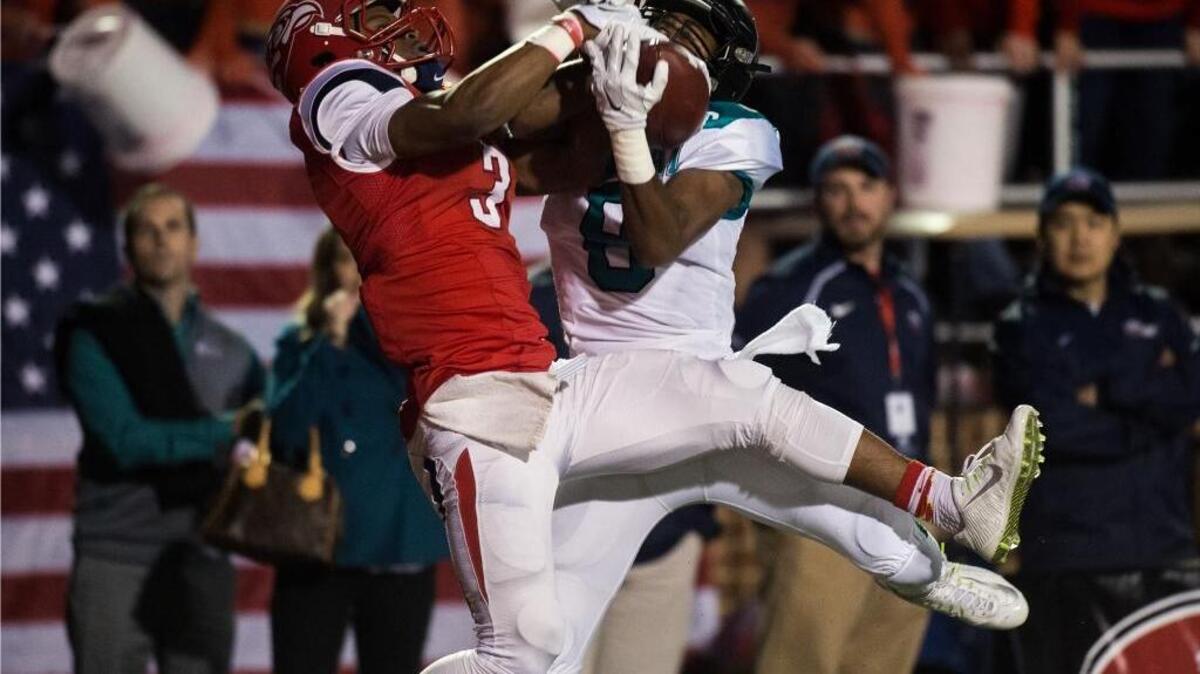 Liberty’s Stephon Masha (left) and Coastal Carolina’s Chris Jones try to gain possession of the ball during Thursday’s game.