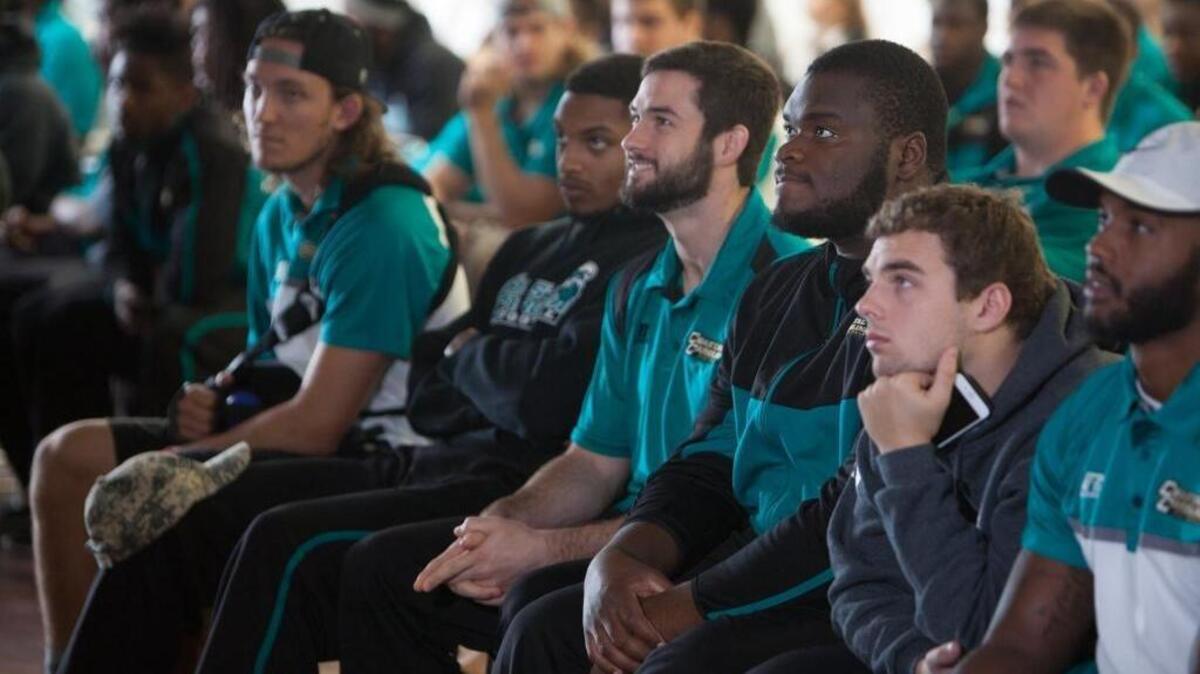 Coastal Carolina players learn their postseason fate as they watch the FCS Selection Show at Adkins Field House.