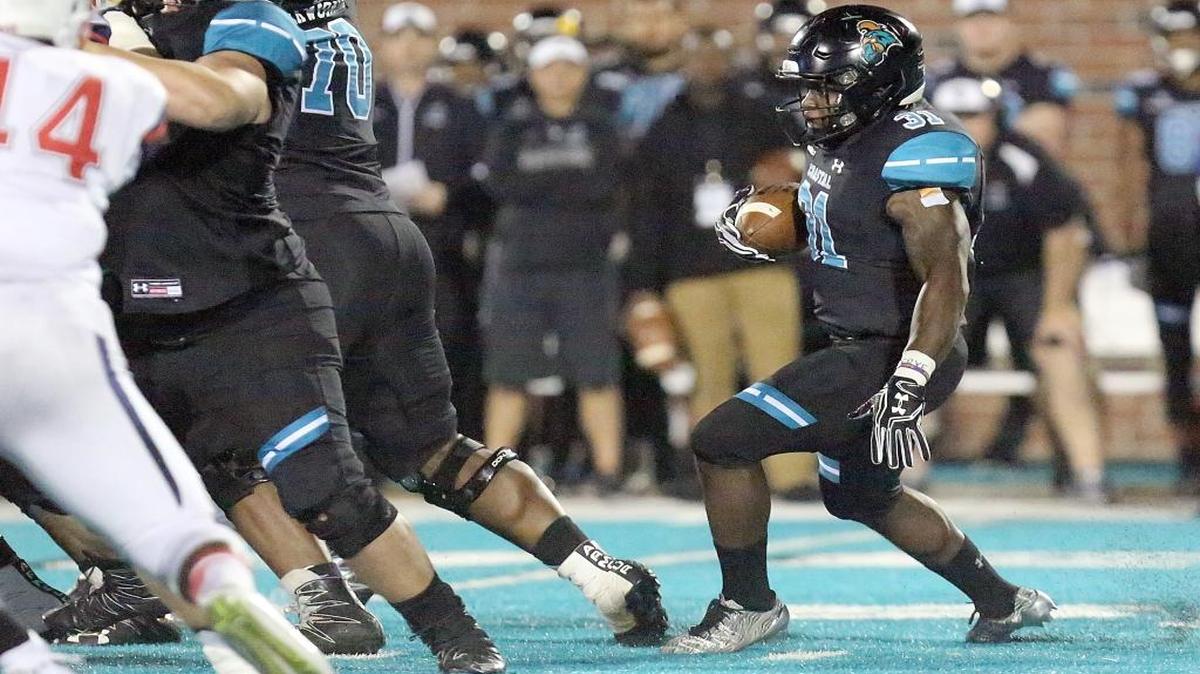 Coastal Carolina’s De’Angelo Henderson looks for running room against Liberty last week.
