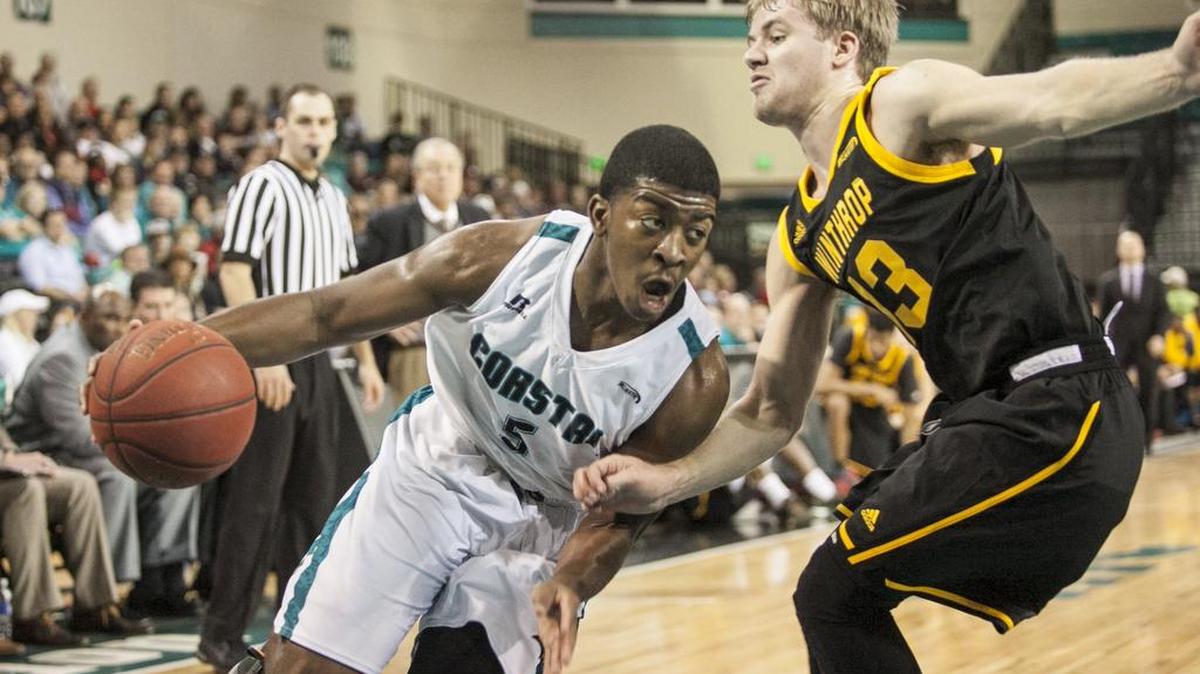 Coastal Carolina’s Jaylen Shaw drives past Winthrop’s Bjorn Broman during a game earlier this season. The Chanticleers open the Big South Tournament Friday night.