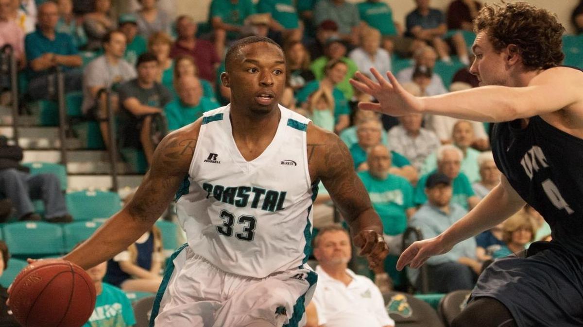 Coastal Carolina’s Ron Trapps (left) looks to drive during Saturday’s win over New Hampshire.