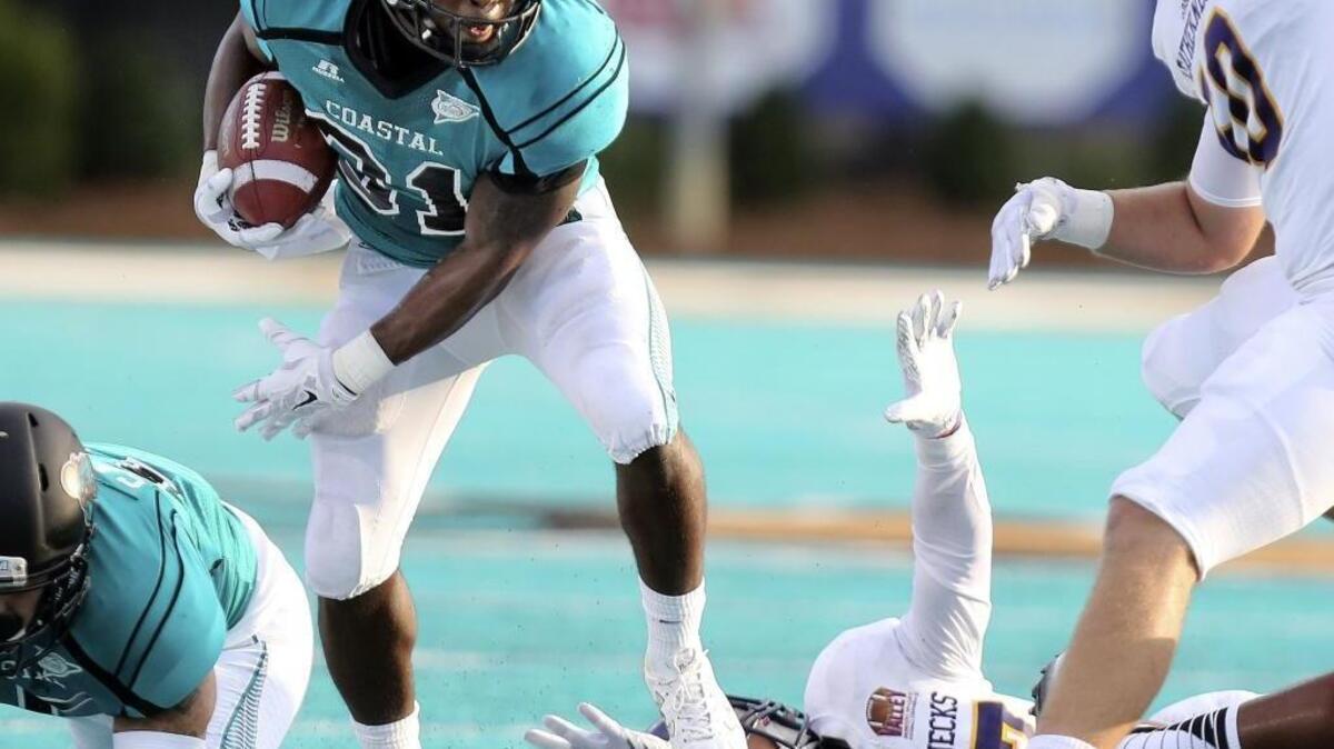 
Coastal Carolina’s De’Angelo Henderson (31) looks for running room against Western Illinois on Saturday.
